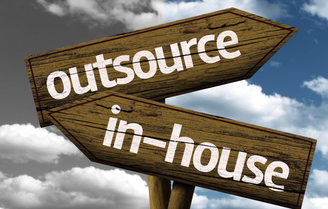 Outsource x In-house creative sign with clouds as the background